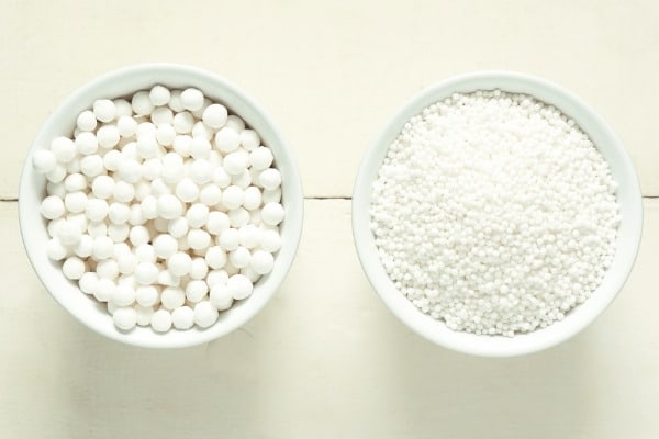 Two white bowls containing large and small tapioca pearls.