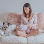 Cairn Terrier sitting on couch with owner