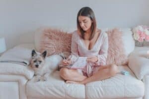 Cairn Terrier sitting on couch with owner