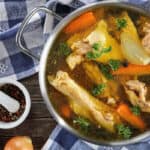 A large pot of chicken and vegetables for chicken broth.