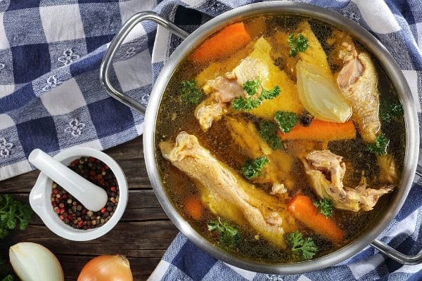 A large pot of chicken and vegetables for chicken broth.